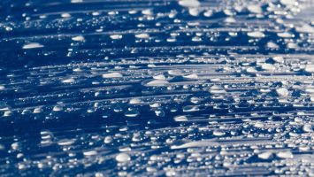 Passive Water-Harvesting Device to Cool Solar Cells and Boost Efficiency